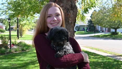 madelyne smiles while holding her loving dog