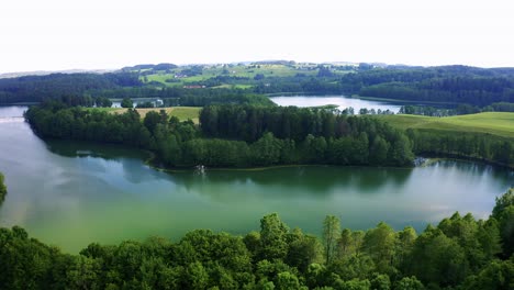 aerial view of famous lake in poland surrounding by the woods