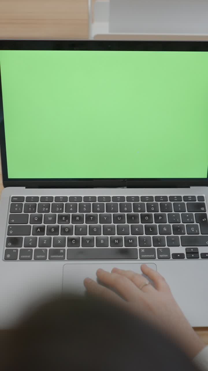 Persona che usa un laptop con uno sfondo verde