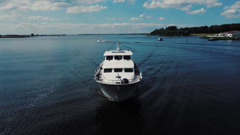 Luxurious-white-yacht-sailing-on-water,-front-view