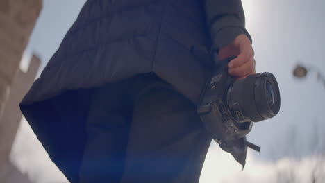 photographer holding camera outdoors