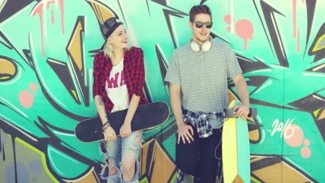 Trendy-young-skateboarders-standing-chatting