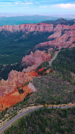 amazing blue skies over the mountainous landscape overgrown with green pine trees. highway going by the tops of wonderful canyons in zion national park, utah, usa. vertical video