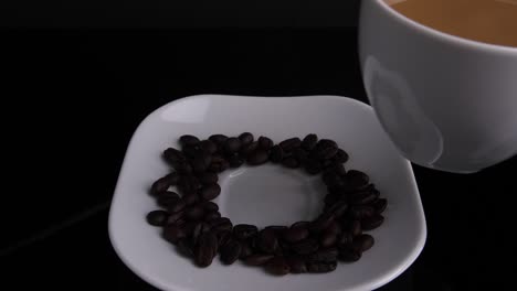 close up of hand placing hot ceramic white coffee cup