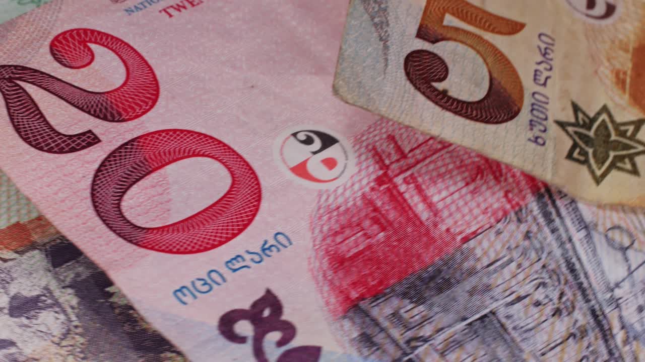 Five Georgian lari banknotes close-up. Universal currency converter GEL Central Bank. 5 lari paper money macro. Economy, financial and banking concept .