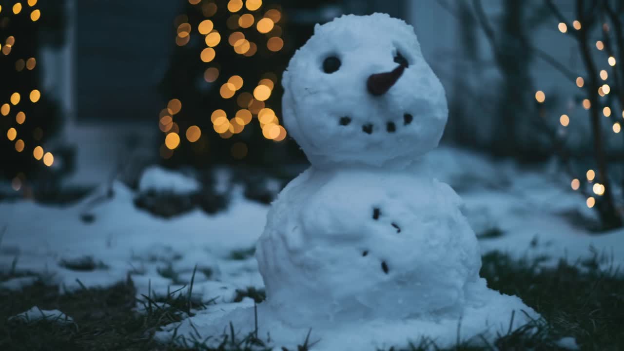 Panning camera revealing snowman drifting off right of grassy front yard, showcasing string lights
