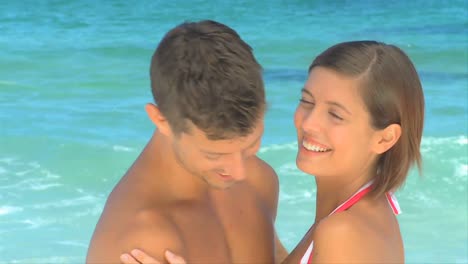 attractive couple hugging on a beach