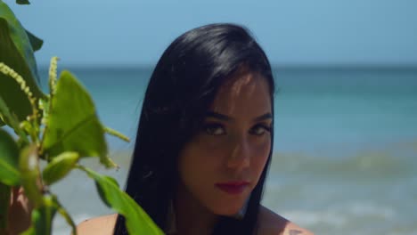 facial close up of a girl at the beach with ocean waves in the background