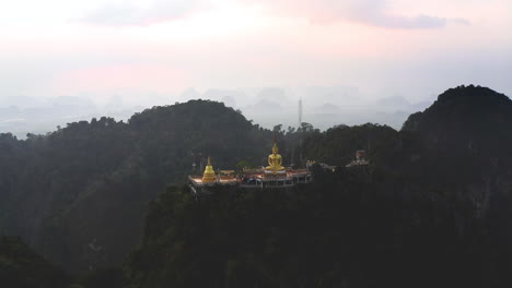 Tiger-Cave-temple-with-golden-Buddha-statue-in-Thai-high-mountains