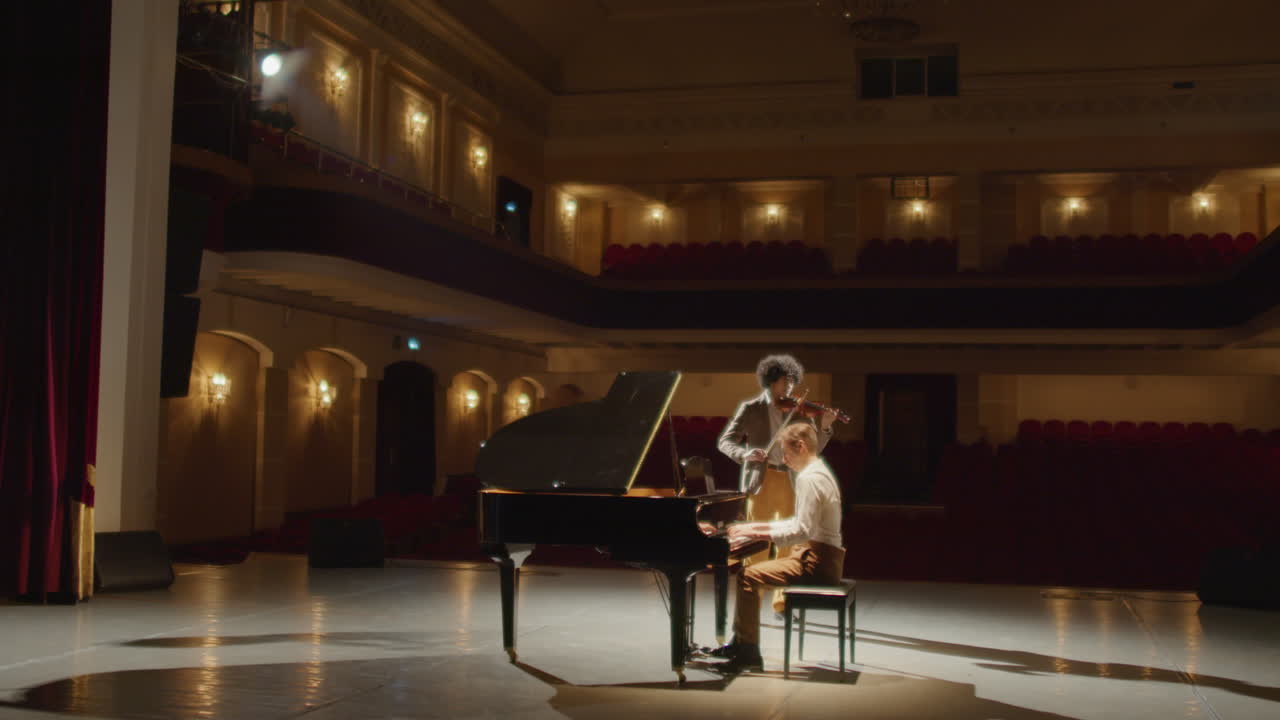 Musicians Playing Violin and Grand Piano in Concert Hall