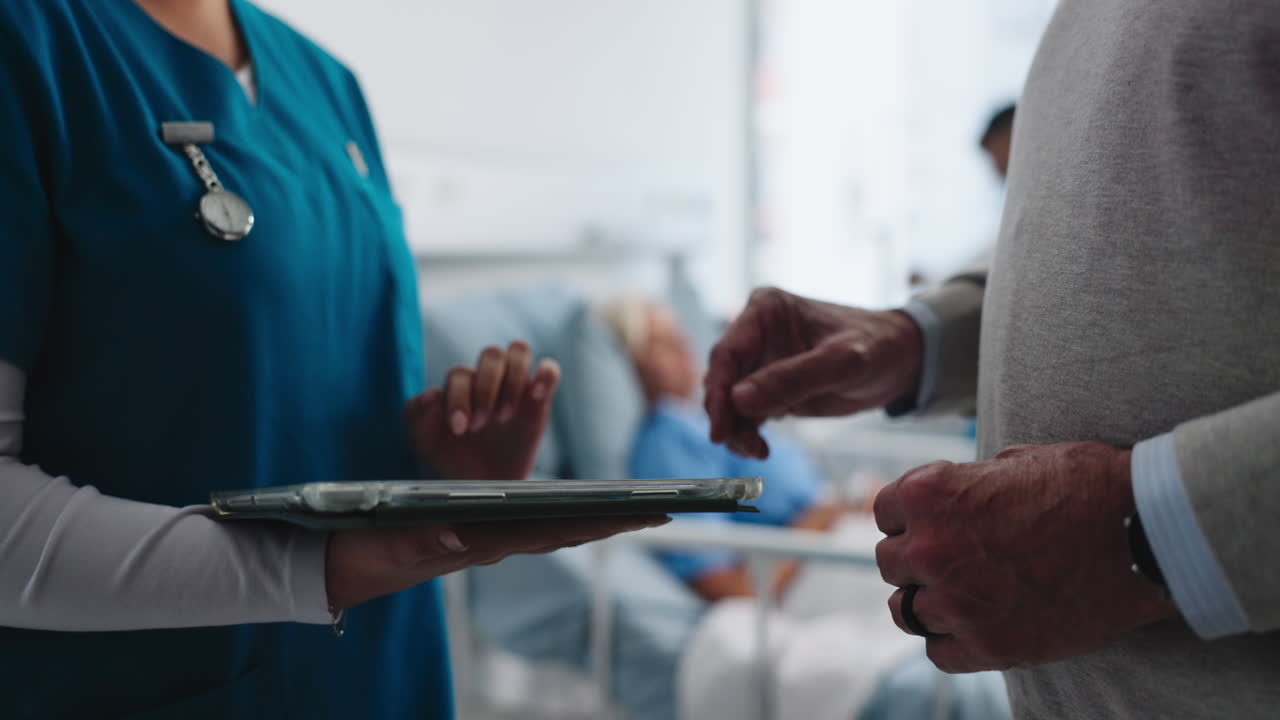 Nurse and Patient's Relative Discussing Medical Information on Digital Tablet