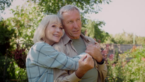 happy senior couple enjoying time together in garden