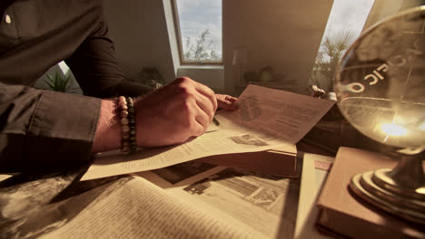 man reading historical documents at a desk