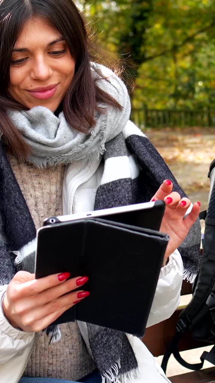Woman using tablet in the park
