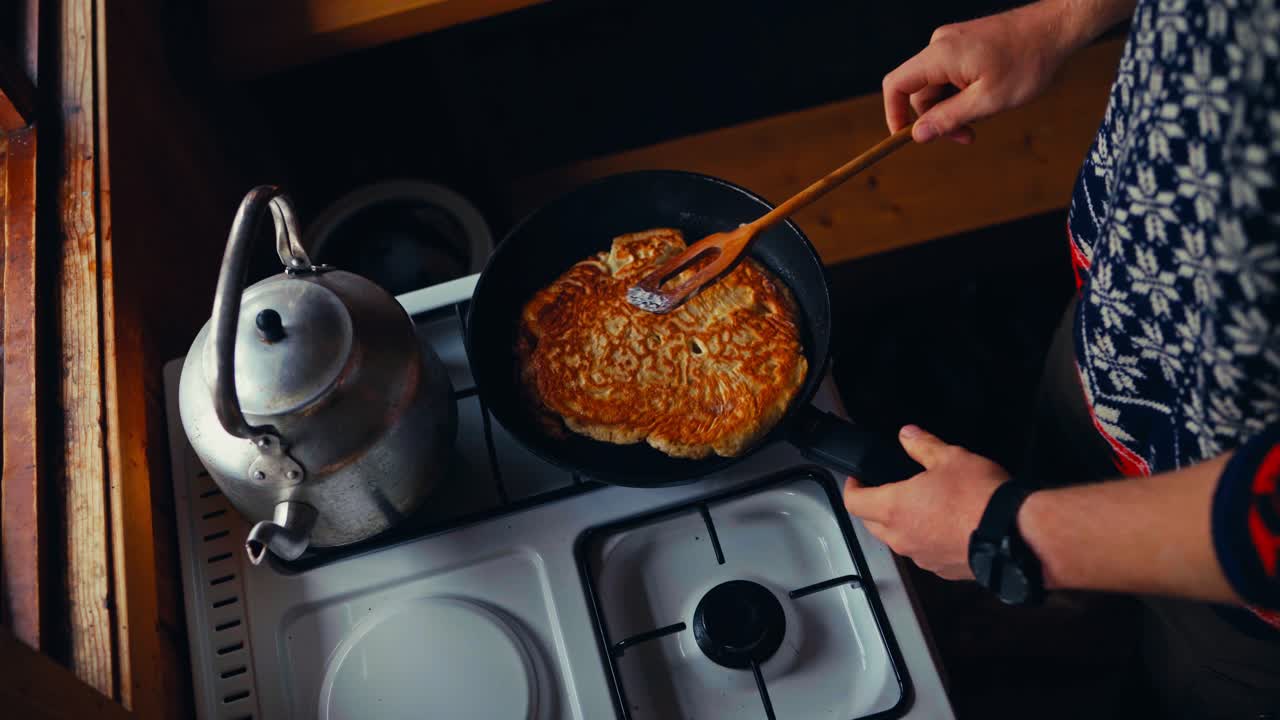 Man Cooking Omelet In Frying Pan On Kitchen Stove - Top View