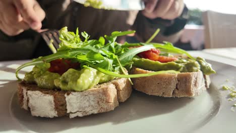 avocado toast with arugula and tomatoes