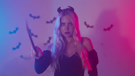 woman in halloween costume with wand