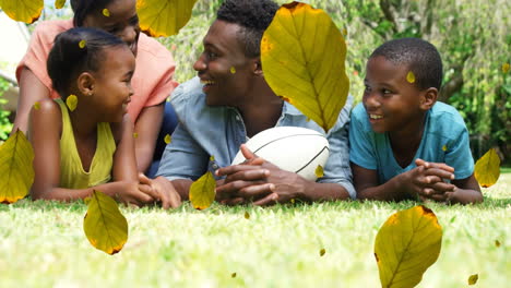 animation of fall leaves over happy african american family in autumn park