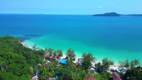 koh rong island with crystal clear turquoise waters, white sandy beach, and a vibrant fishing village nestled along the coastline. fantastic aerial view flight panorama overview drone