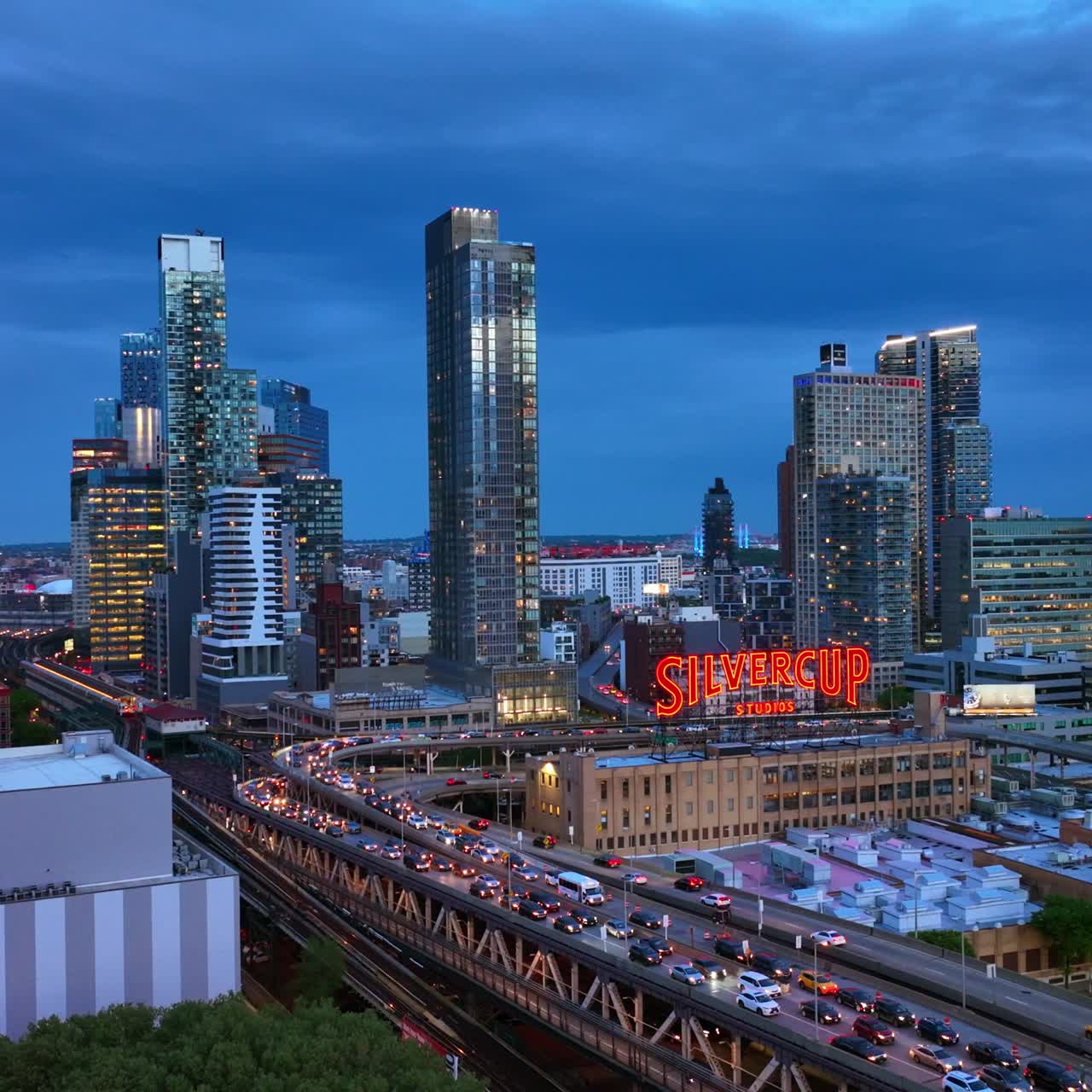 Long Island City, Queens, New York. Gorgeous modern buildings full of lights. Busy traffic around Silvercup Studios in the evening