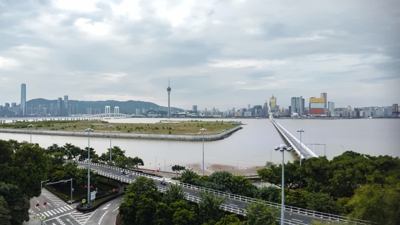 Timelapse of newly reclaimed land between Macao Peninsula and Taipa beside the Governador Nobre Carvalho Bridge, with the skylines of Macao and Hengqin in the background