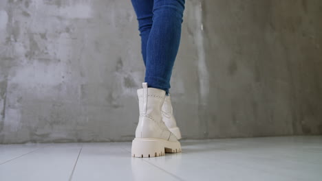 cream colored platform boots with blue jeans