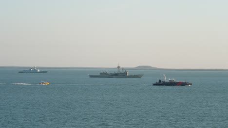 australian border force cape class patrol boat passes hmas newcastle and ins trishul