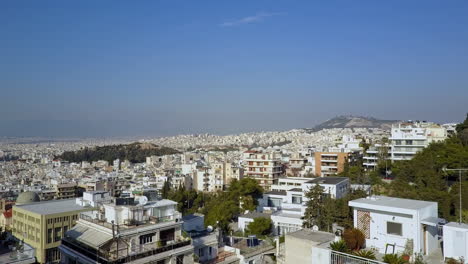 low aerial shot pushing past buildings over athens greece, 4k