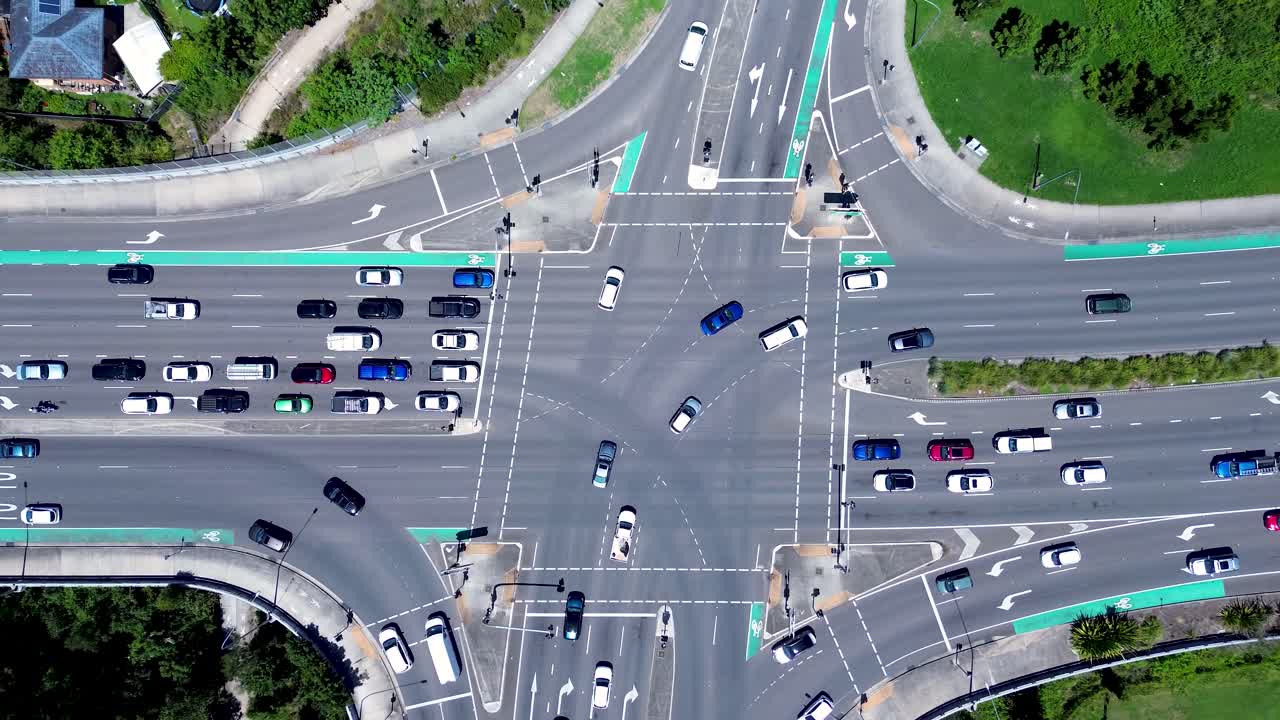 Drone aerial landscape of car vehicles traffic and transport driving on intersection traffic lights roads street of Tuggerah Central Coast Australia streetlight crossing urban infrastructure