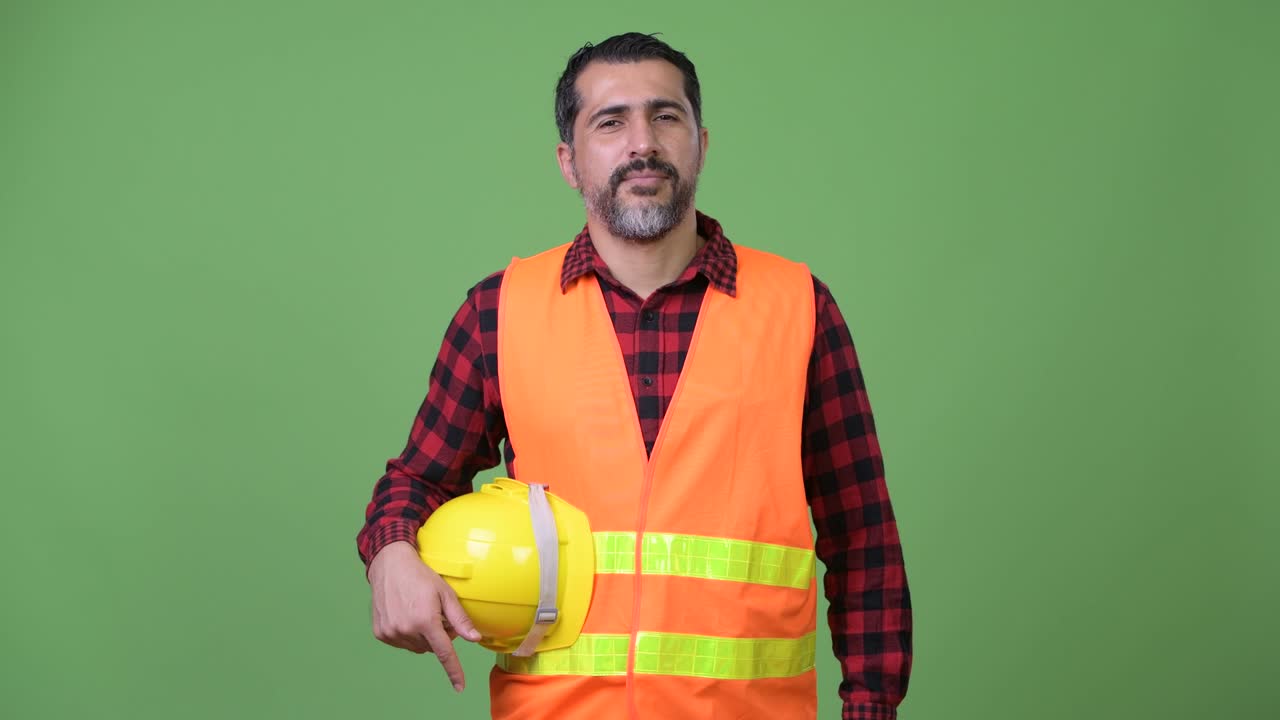 Handsome Persian bearded man construction worker smiling