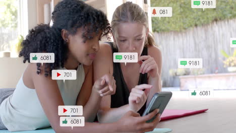 animation of social media text and icons over diverse girlfriends using smartphone