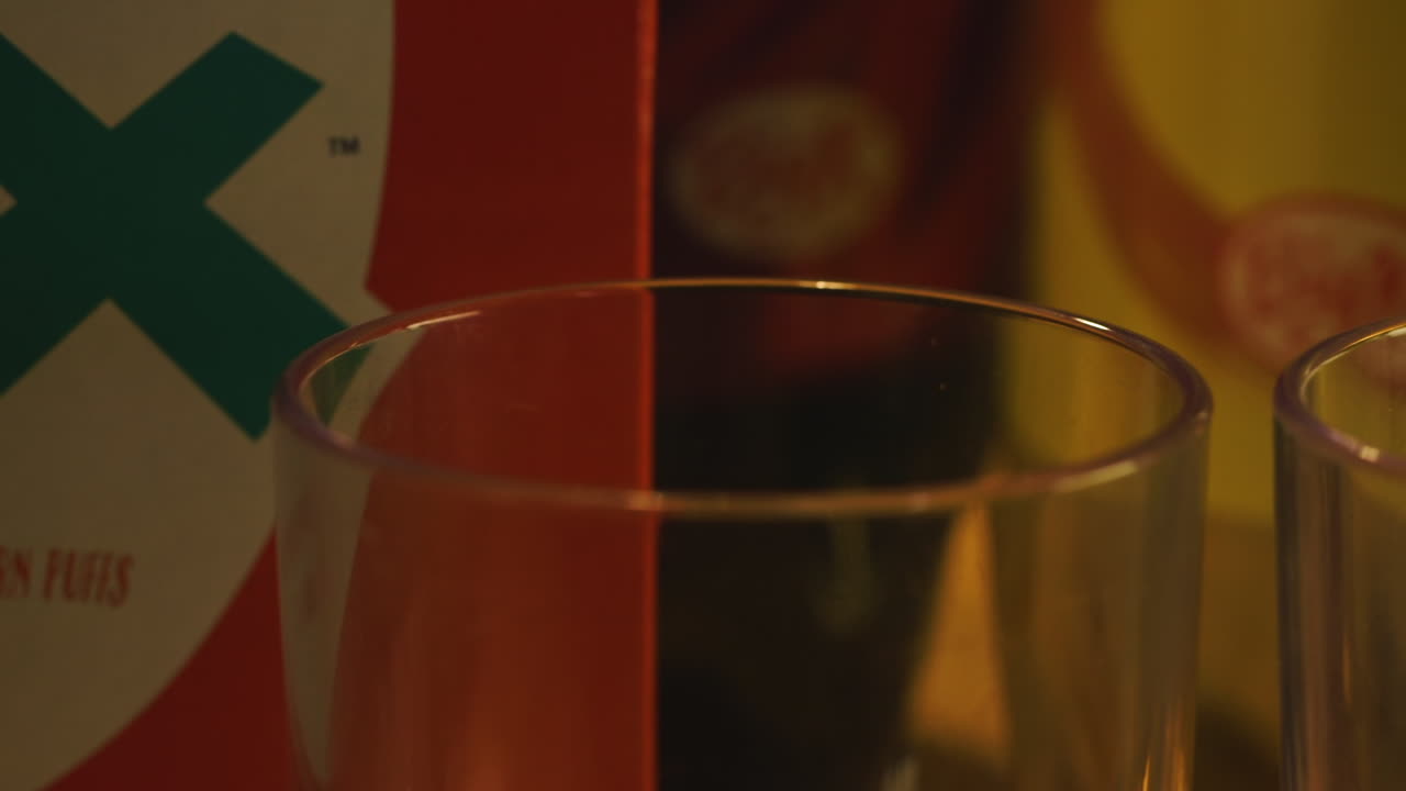 Pan Across Two Drinking Glasses and Cereal Box, Close Up in Dark Room