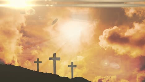 animation of three christian crosses with glowing sun rays over orange sky