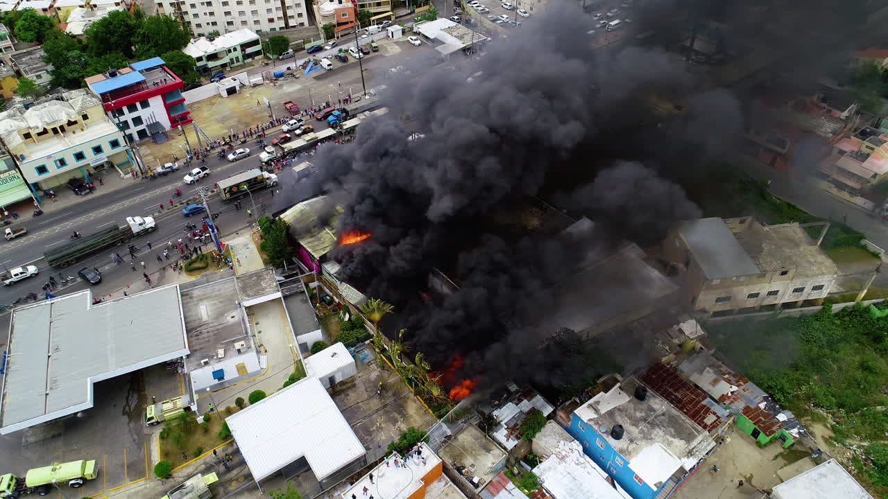 Aerial view around a raging building fire, smoke rising due to a accident, in Rio de Janeiro, Brazil - orbit, drone shot