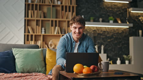 happy freelancer feeling success looking laptop at home. businessman rejoicing