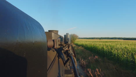 view from a moving train along a green field