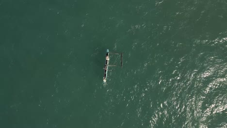 aerial drone shot of fishermen in a traditional african fishing canoe