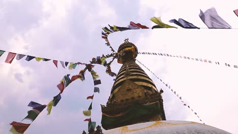 spire of the great stupa of boudhanath among of prayer flags on a background of clear sky, kathmandu, nepal