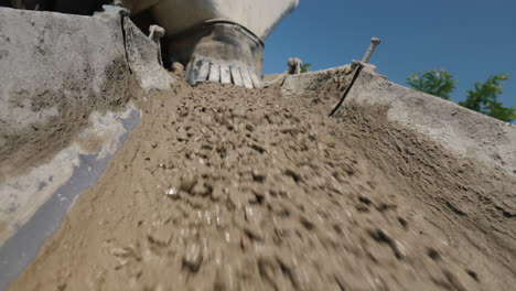 concrete flows from the concrete mixer through a trough 1