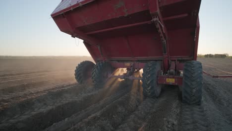 a tractor with blades cuts holes to prepare the field before planting. agricultural machinery.