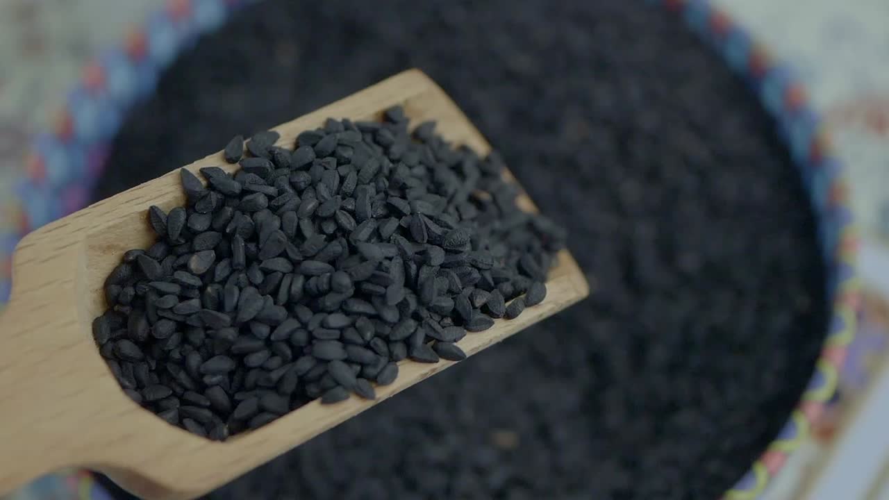 Black Cumin Seeds in Wooden Scoop