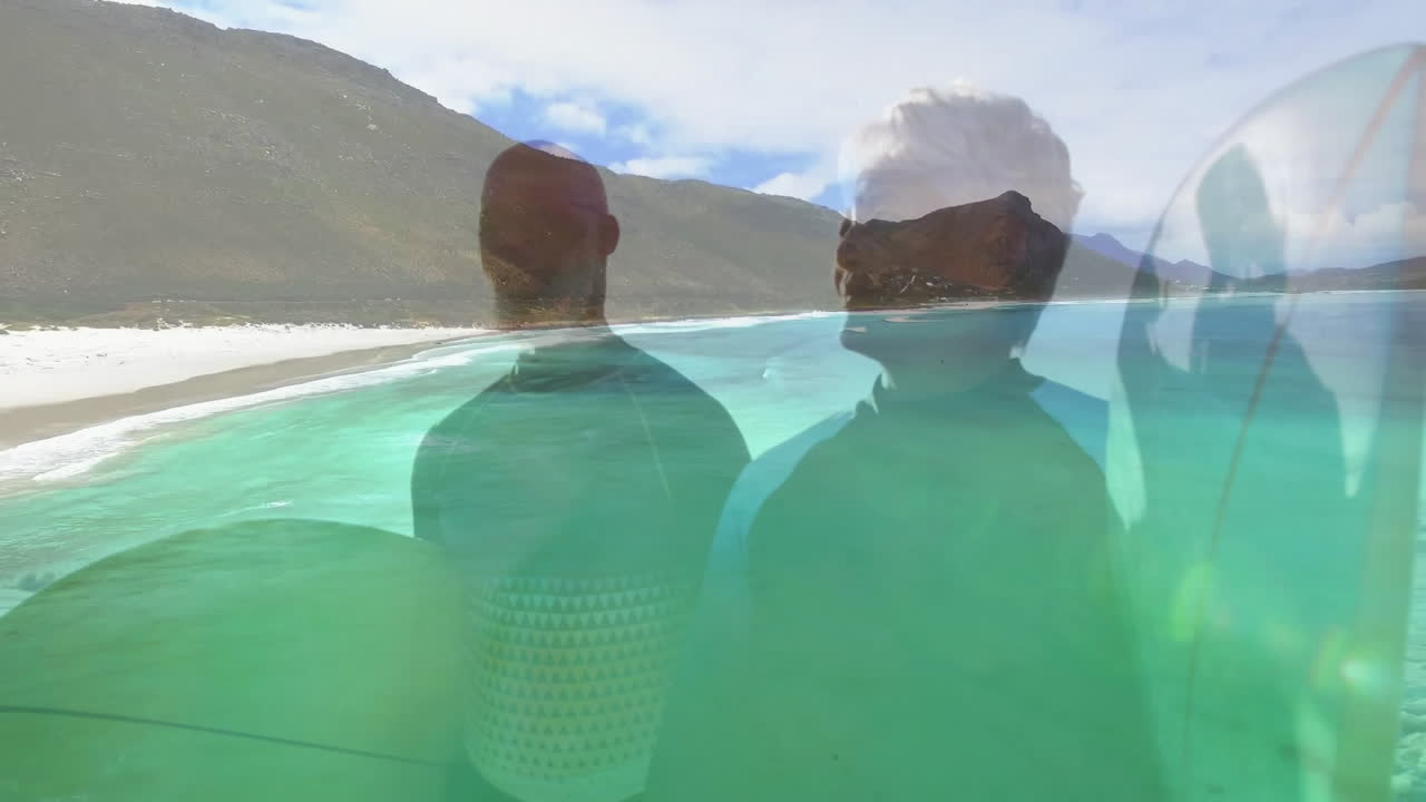 Two surfers standing chest-deep water at beach, showing surfboards and animated health wave chart