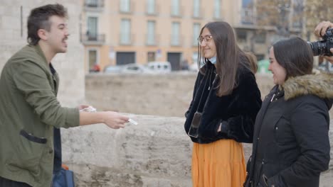 street scene interaction with magician and young adults