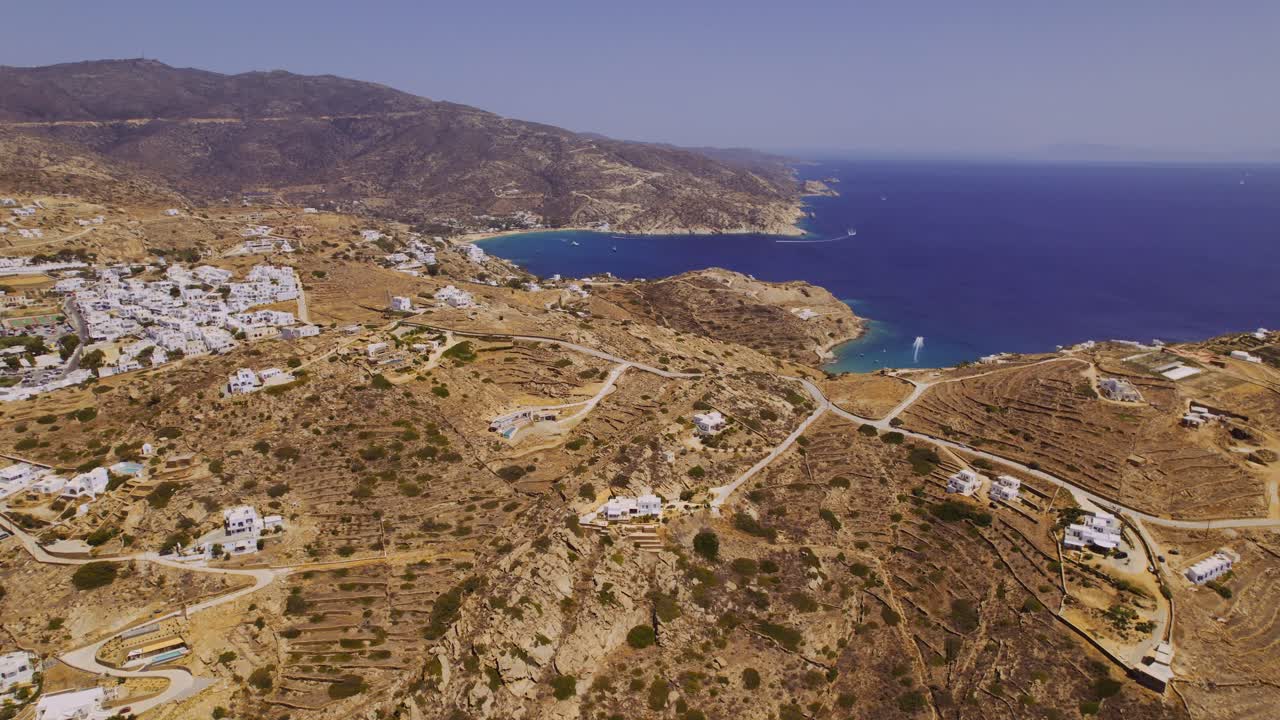 Aerial View of a Coastal Village on a Dry Hilly Landscape with Blue Sea