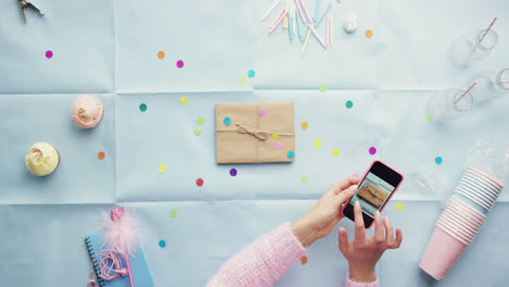 Top-view-woman-using-mobile-phone-present--Birthday-Party-planning-hands-from-above---Red-Epic-Dragon