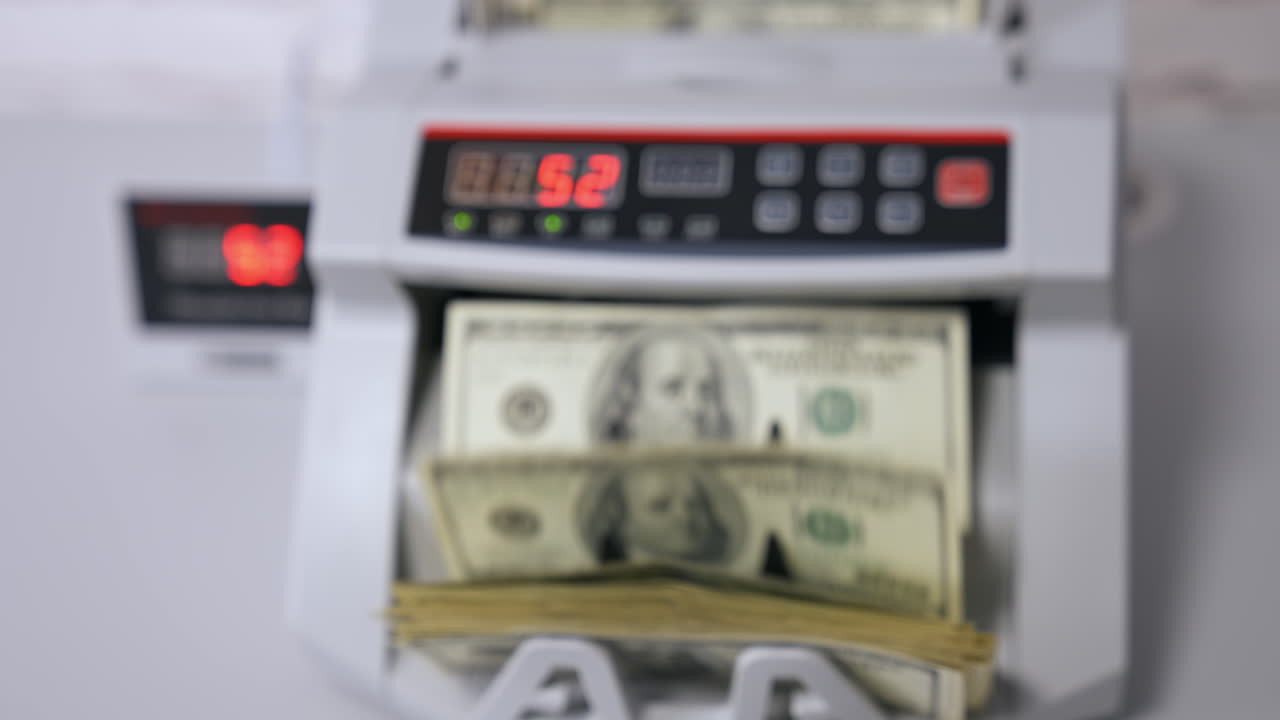 Money counting equipment for paper money calculation. Automatic mechanism for bank financial operations. Currency exchange of one hundred usd.