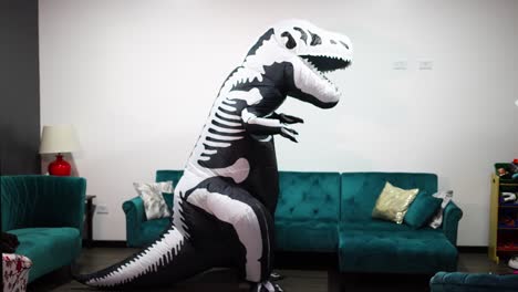 man in skeleton dinosaur halloween costume in the living room of the house