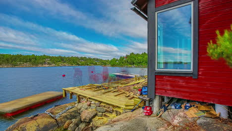 time lapse of two people building a wooden porch in front of a rustic lake house