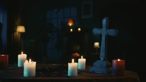 video capturing a table with magical tools on it a priest is sitting at the table with beads in his - video capturing a table with magical tools on it. a priest is sitting at the table with beads in his hands, praying with his eyes closed, when a hand lays on his shoulder. creative content, hallowee