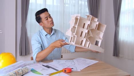 young architect hold house model and looking about new architectural